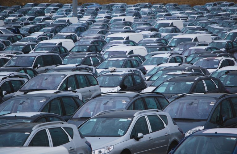 Exterior view of a few used cars for sale at a used car dealership