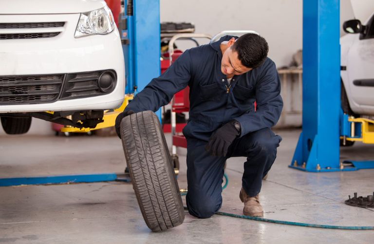 A service technician repairing a car