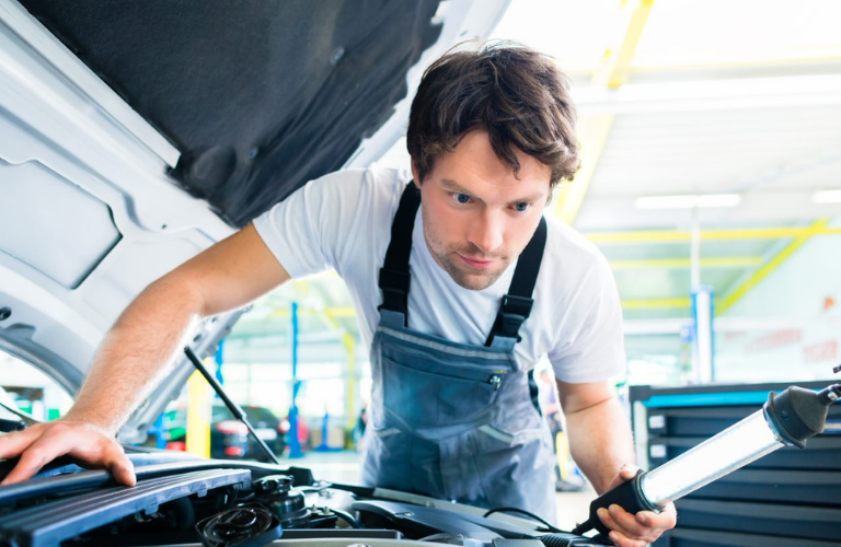 Mechanic looking over an engine